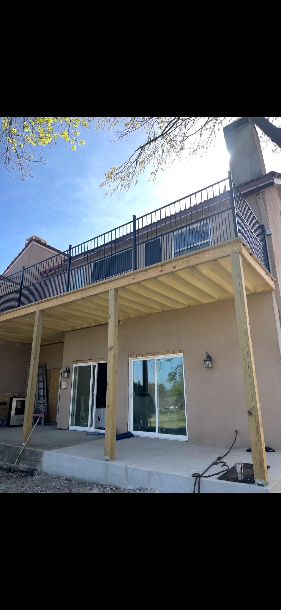 Second story deck build with iron railing