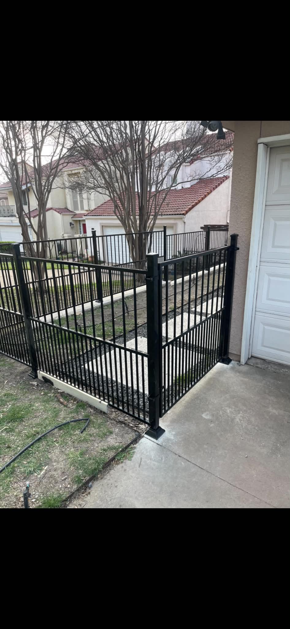 Black wrought iron fence and gate installation