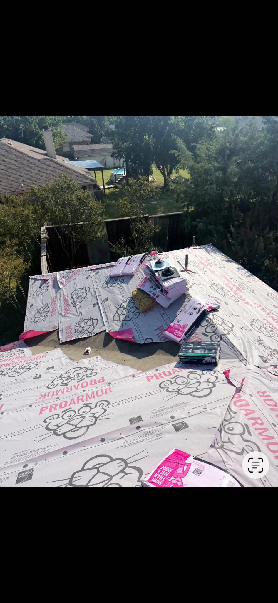 Roof underlayment being installed